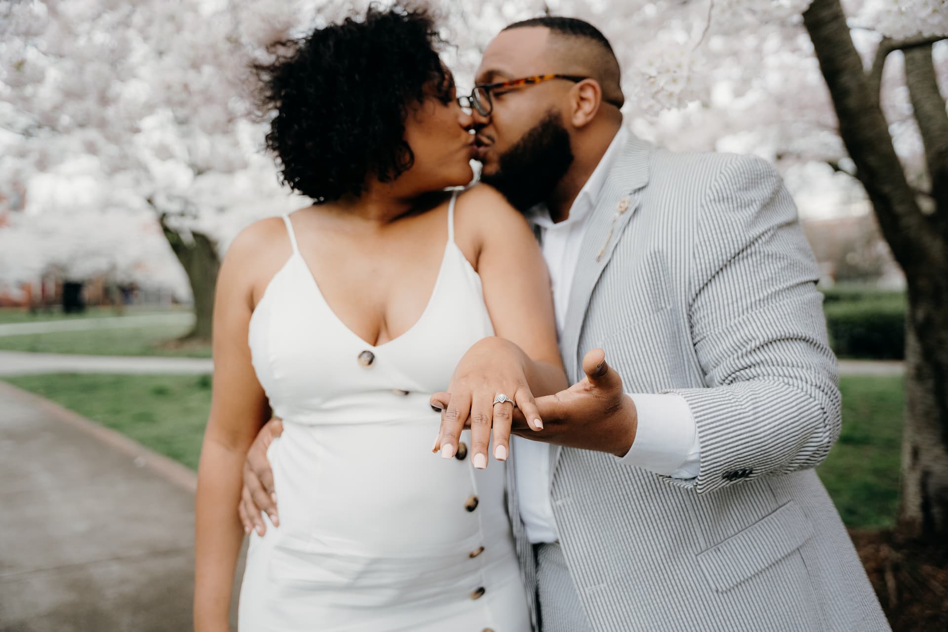 Engaged couple posing in coordinated outfits