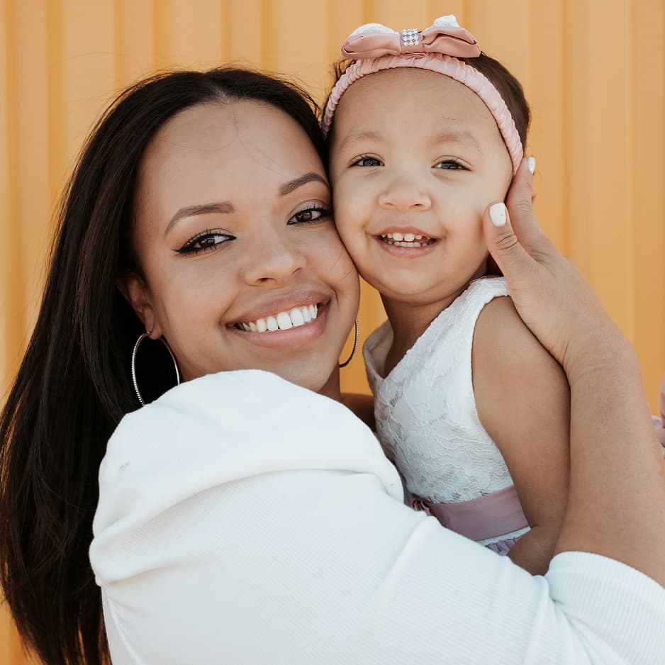 mother posing with a baby for a "mommy and me" photoshoot