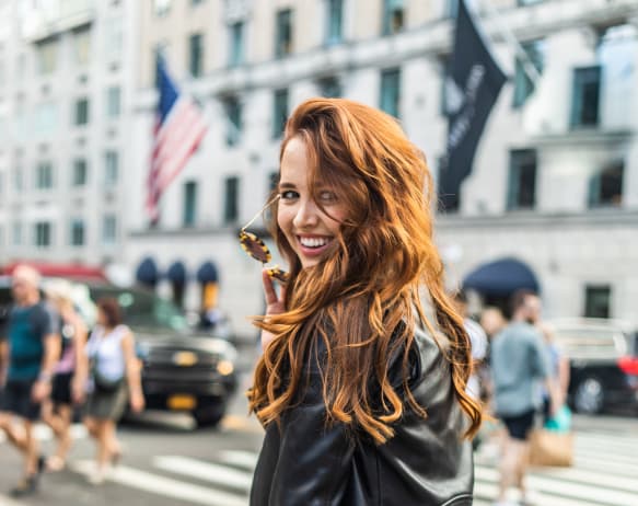 woman posing for a phote on a busy street