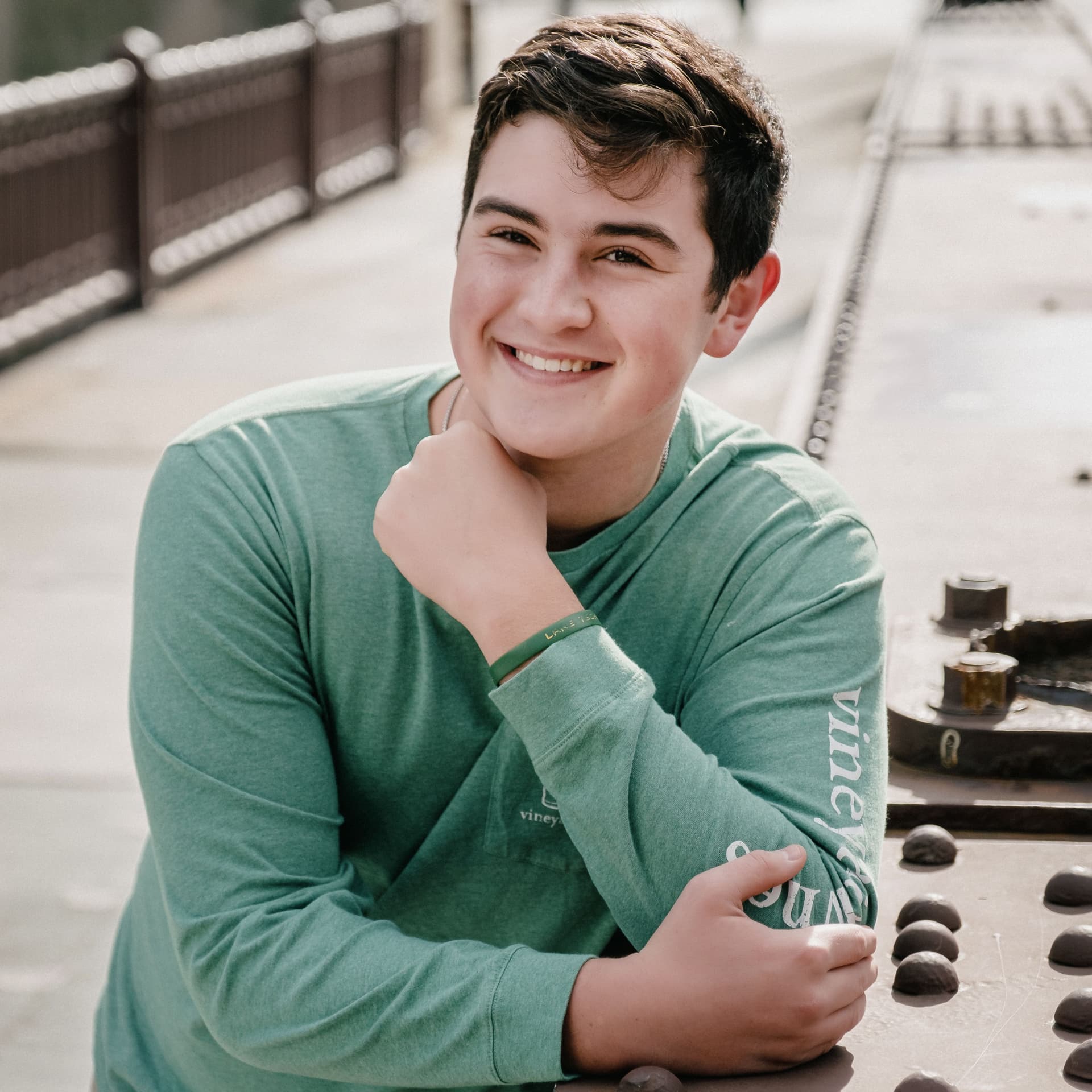 Boy poses outdoors for his free senior portrait photoshoot