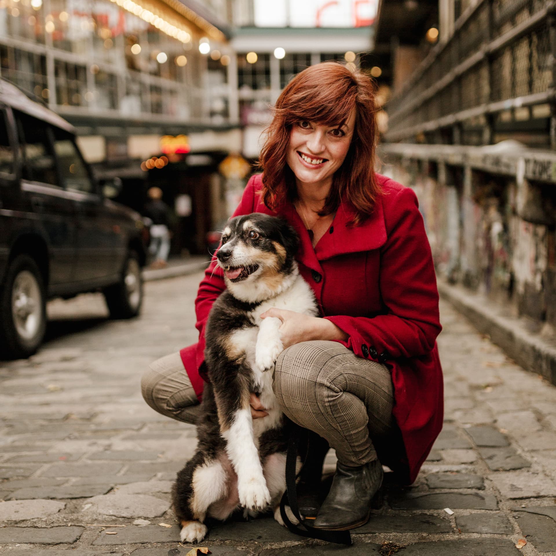 Woman poses with her pet dog in front of the iconic public market for her free outdoor pets photoshoot