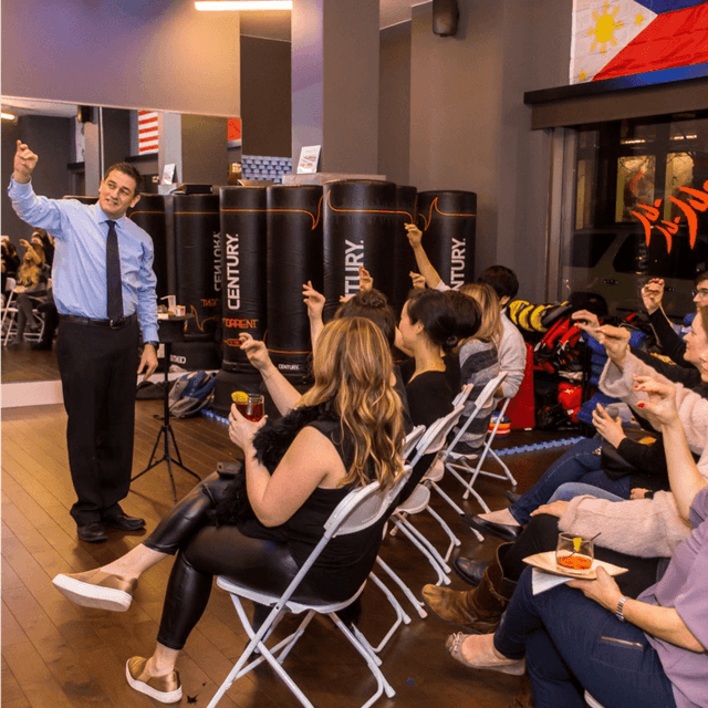 A man giving a presentation to a group of seated people.
